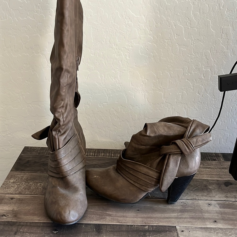 Brown faux leather knee high boots.